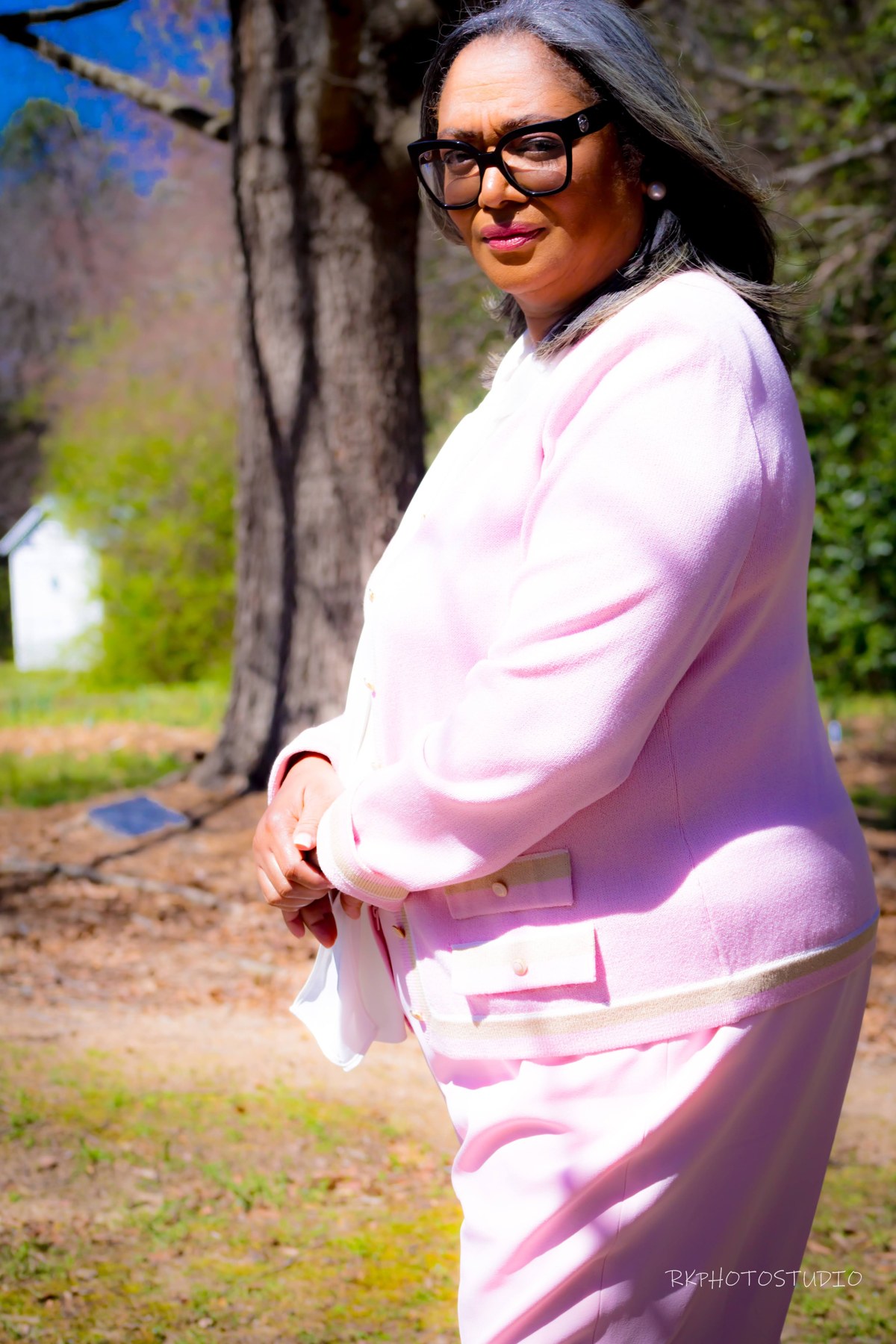 Teacher Cassandra Mitchell outdoors in a pink suit